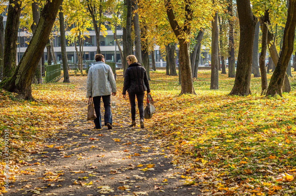 Two Mature women walk in the city Park