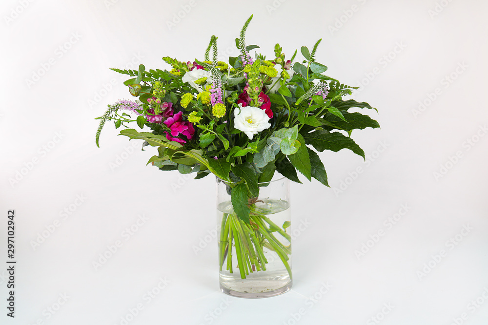 Obraz premium Bouquet of flowers in a vase isolated on white.
