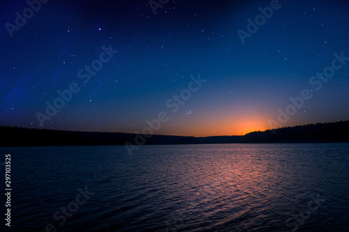 sunset with starry sky over a lake