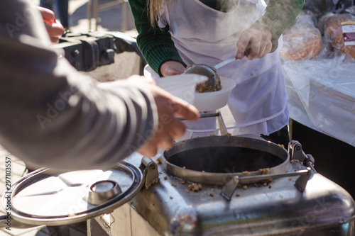 preparing a meal in the kitchen of field and feeds people on the street.