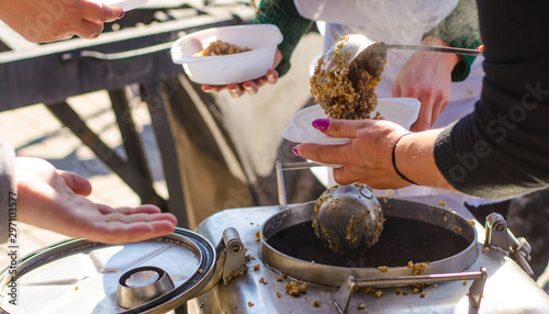 preparing a meal in the kitchen of field and feeds people on the street.