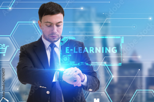 The concept of business, technology, the Internet and the network. A young entrepreneur working on a virtual screen of the future and sees the inscription: E-learning