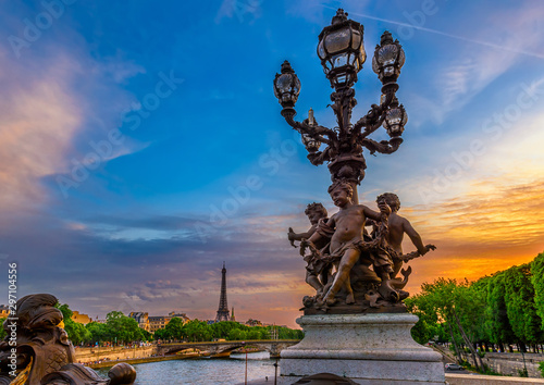 Street lantern on the Alexandre III Bridge with the Eiffel Tower in the background in Paris, France