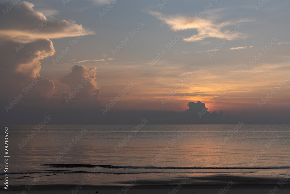 Beautiful cloudscape against sand beach in sun rise time