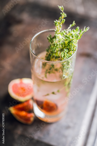 Sweet cocktail with figs liqueur and thyme. Selective focus. Shallow depth of field.