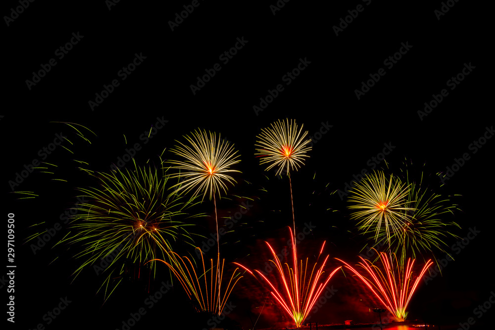 fireworks new year celebrate -  beautiful colorful firework isolated display with light reflex in water display for celebration happy new year and merry christmas on black isolated background