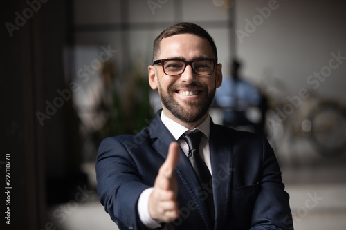 Happy professional businessman employer consultant extending hand at camera