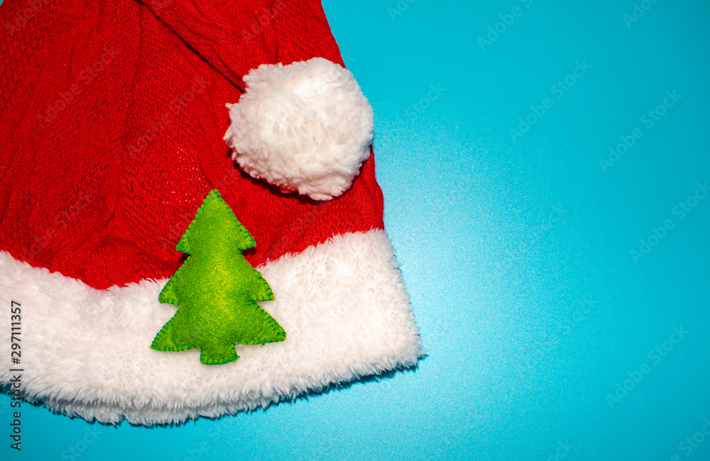 Gorgeous Santa Claus hat on a blue background with elements representing Christmas. Gorgeous Santa Claus hat on a blue background with elements representing Christmas.