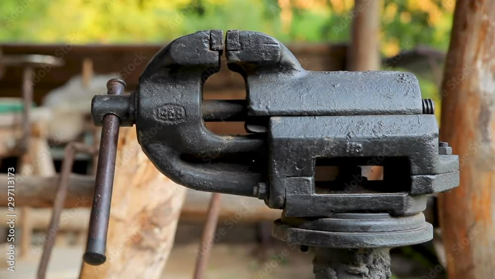 old massive black vise clamp close-up in an open air workshop on a ranch old massive black vise clamp close-up in an open air workshop on a ranch