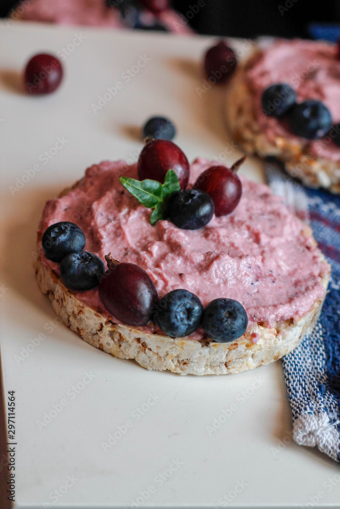 cream, blueberries and gooseberries on toasts cream, blueberries and gooseberries on toasts