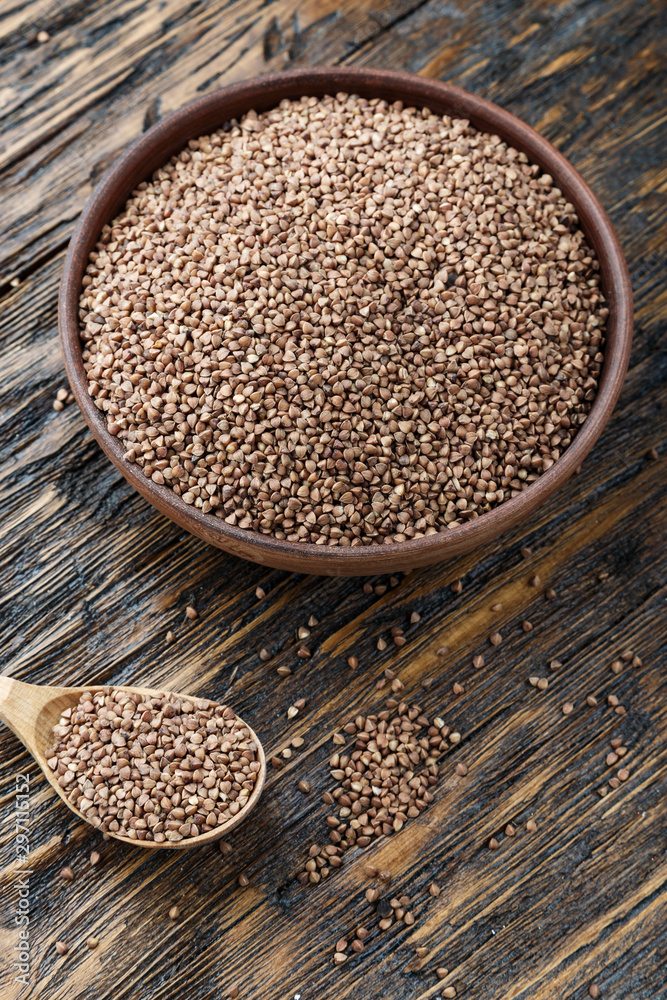 buckwheat in a plate on a wooden background