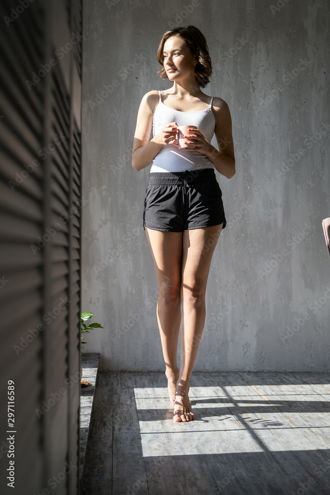 Smiling woman drinking a cup of coffee Smiling woman drinking a cup of coffee