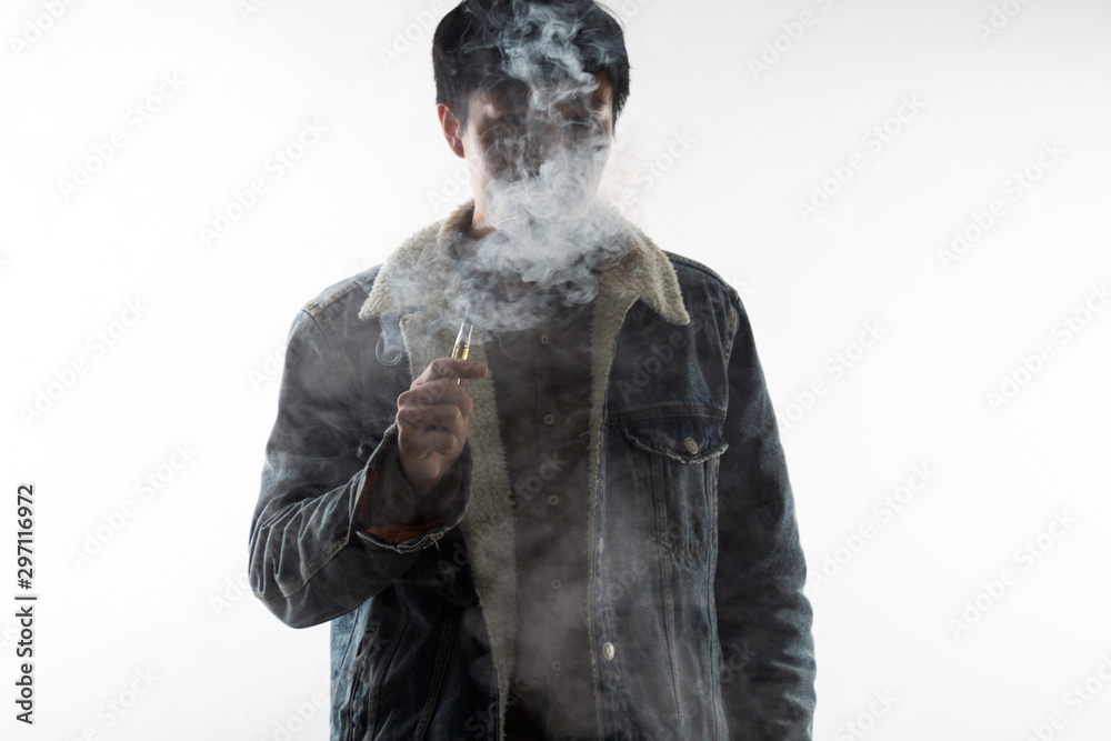 Man vaping an electronic cigarette. a lot of smoke.