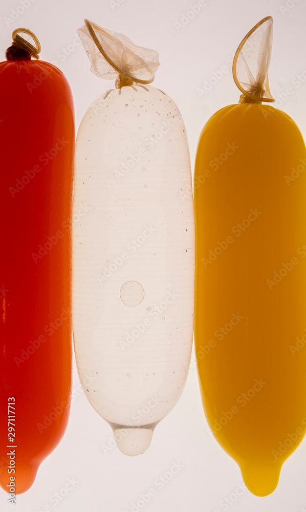 Condoms filled with colorful water, isolated on a white background. Condoms filled with colorful water, isolated on a white background.