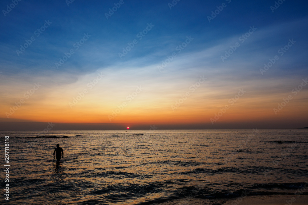 Scenic view of a summer sunset on the Ionian sea near Gallipoli, a town in the Apulian region (Italy). Landscape format.