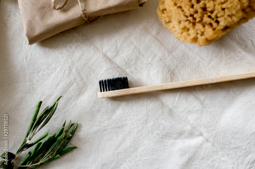 eco natural bamboo toothbrushes in glass on rustic background with greenery. sustainable lifestyle concept. zero waste home. bathroom essentials, plastic free items
