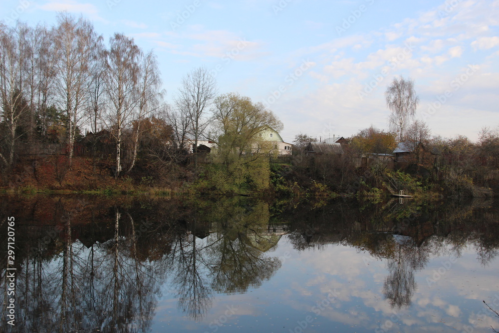 Autumn country landscape of calm water reflecting bueautiful clouds on blue sky Autumn country landscape of calm water reflecting bueautiful clouds on blue sky
