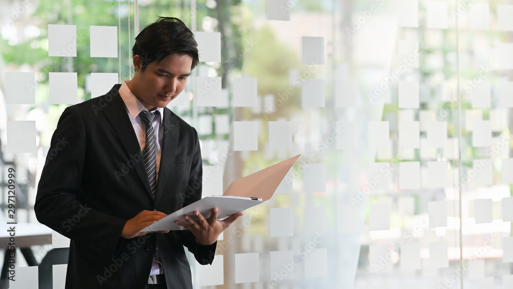 Businessman reading a report document work paper. Businessman reading a report document work paper.