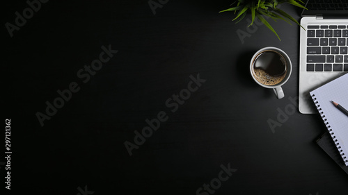 Copy space office black table with laptop, notebook, pencil and coffee cup with plat.
