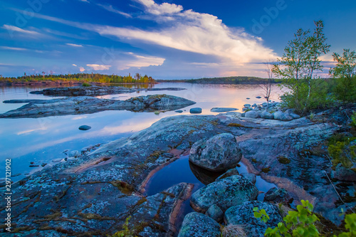 View of Karelia at sunset. Rocky Islands in lake Ladoga. Northern nature. Sights Of Russia. Outdoor recreation. Fishing. Natural landscape in blue tones.