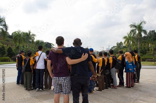 two men making photobomb and disturb group who are taking pictures of themselves photo