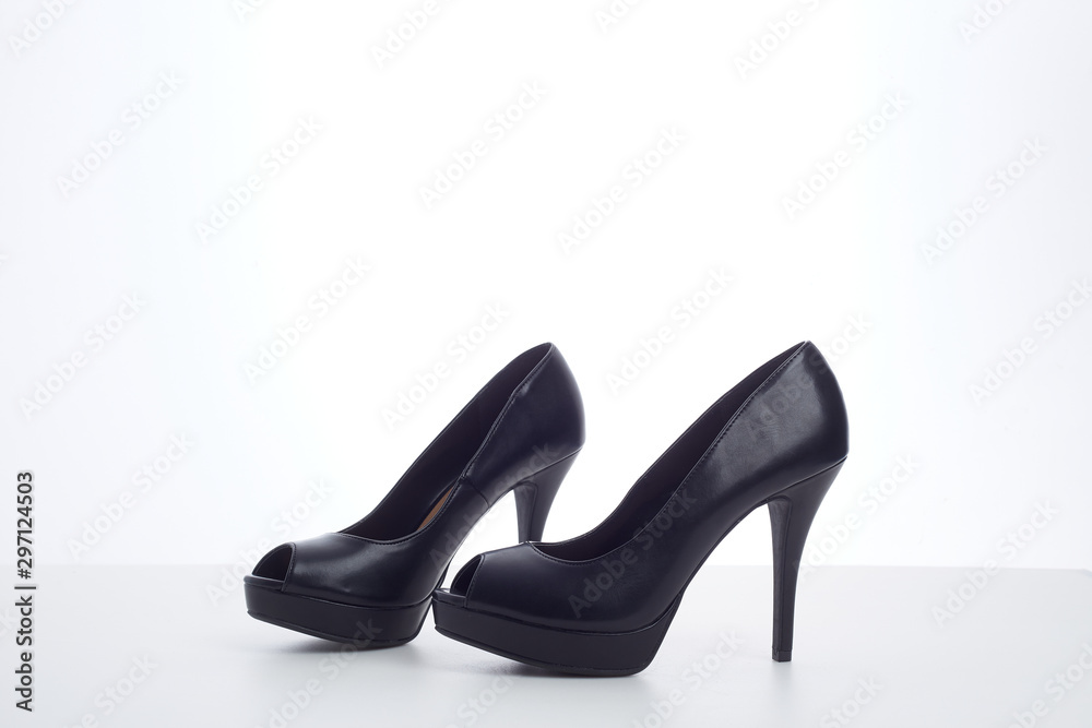 black high-heeled shoes on white