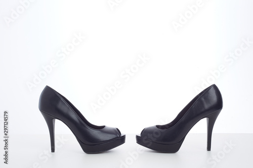 black high-heeled shoes on white