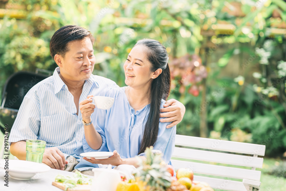 couple laughing and having a good time in the morning while drinking coffee couple laughing and having a good time in the morning while drinking coffee