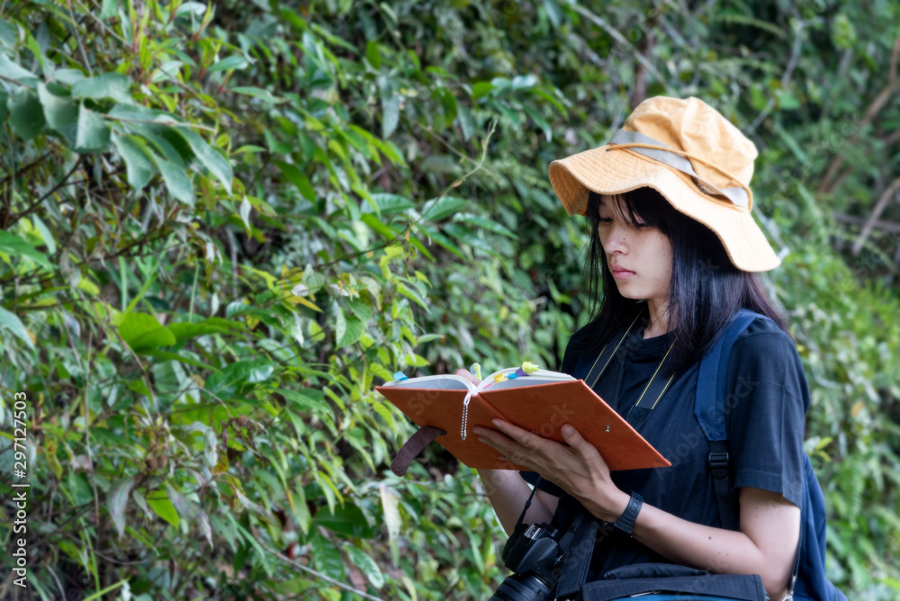 Biology asian woman scientist travel and reseach kind of plants in forest.