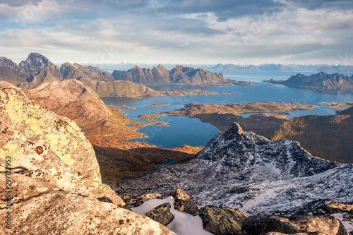 Panorama view from the mountain Rundfjellet to the surrounding snow capped peaks and the sea on the Lofoten Islands, Norway