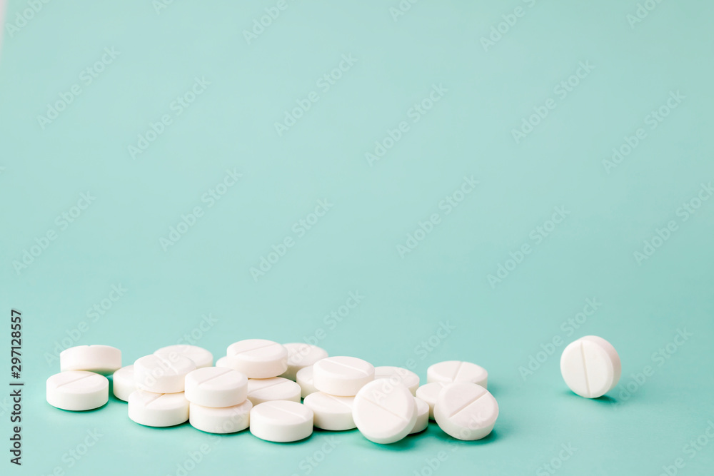 Heap of white round pills close-up Heap of white round pills close-up