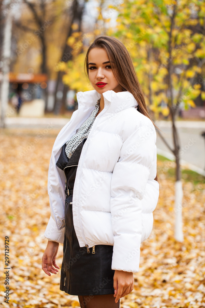 Portrait of a young beautiful woman in a white down jacket Portrait of a young beautiful woman in a white down jacket