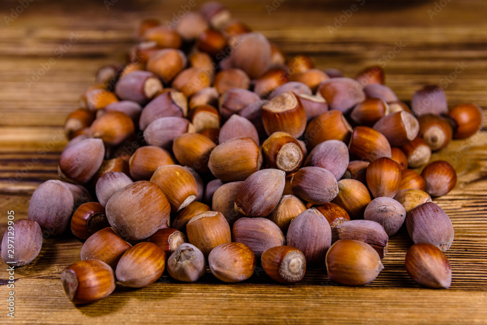 Pile of the hazelnuts on wooden table Pile of the hazelnuts on wooden table