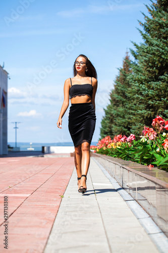 Sexy woman walking in summer street