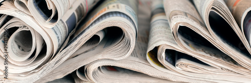 Newspapers, world news information concept, close-up, panoramic photo