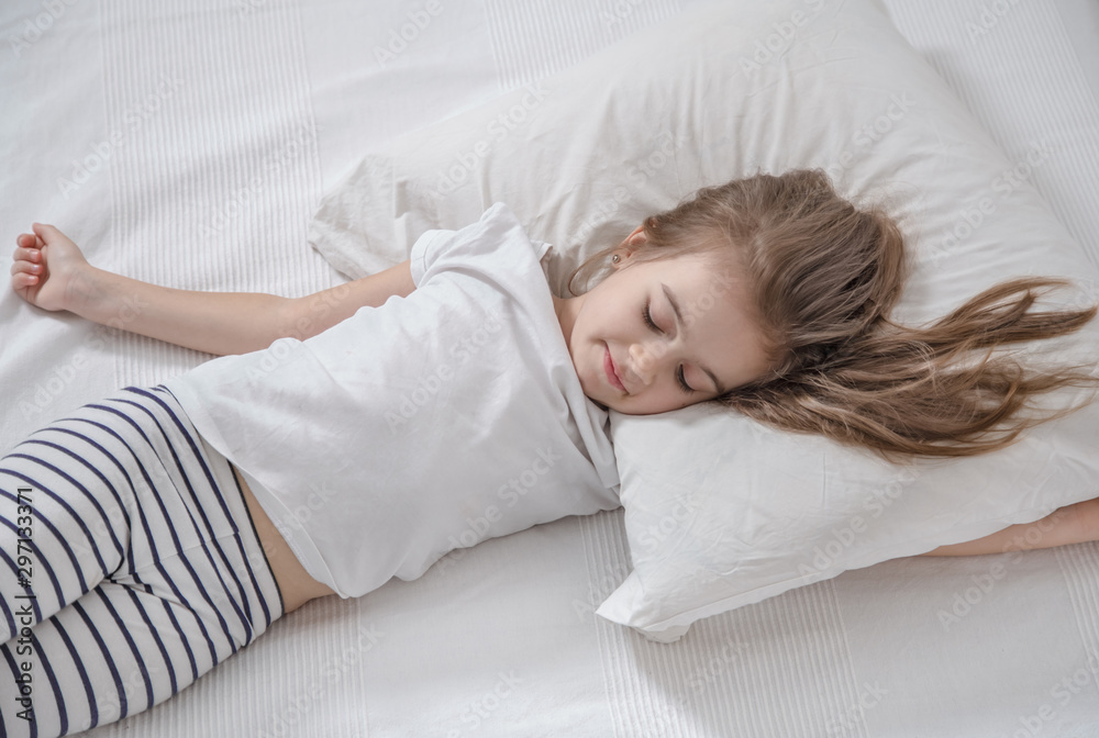 Cute little girl with long hair sleeping in bed. Cute little girl with long hair sleeping in bed.