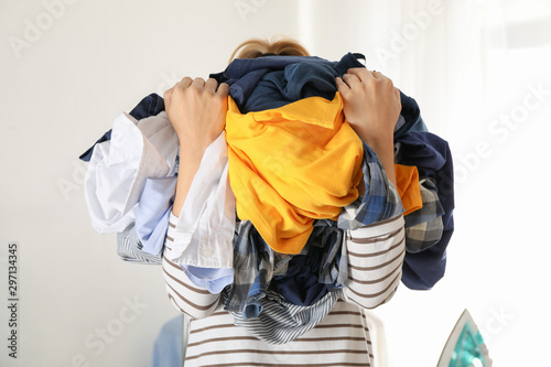 Young woman hold crumpled clothes, space for text