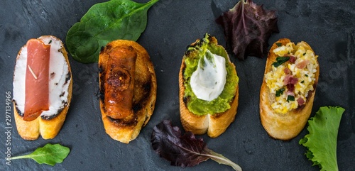 Spanish tapas on a slate plate with lettuce leaves as decoration