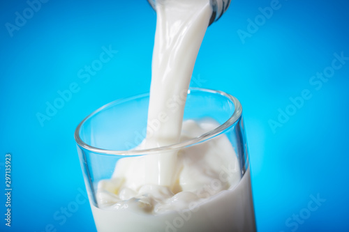 milk pouring from bottle into glass