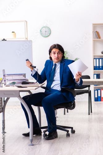 Young businessman sitting and working in the office