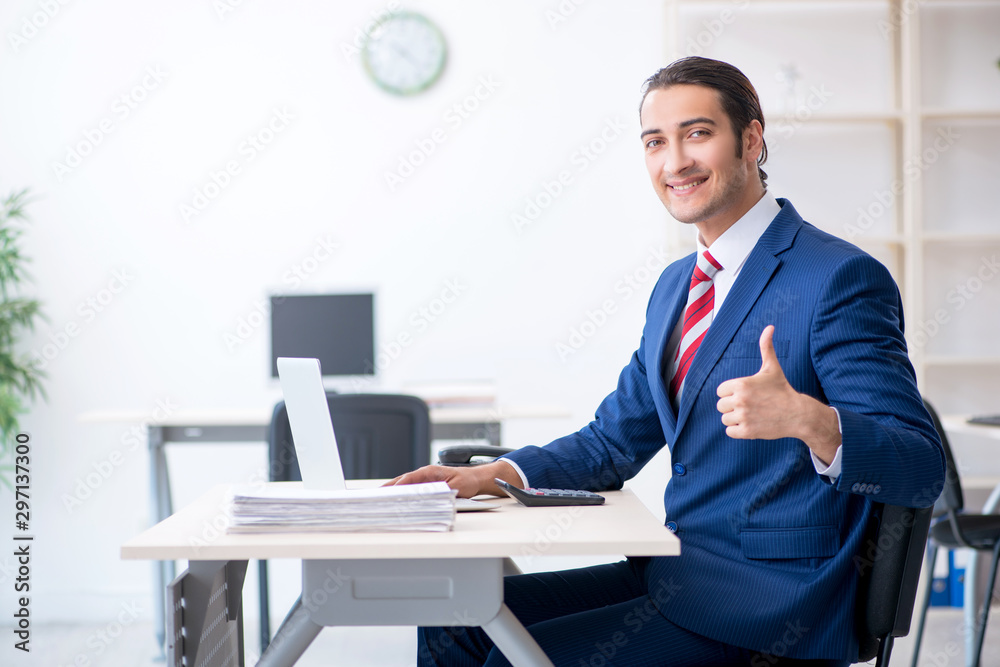 Fototapeta premium Young male businessman sitting in the office