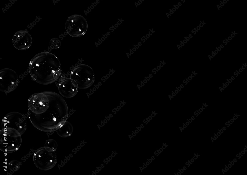 Clear soap bubbles floating on black background with copy space Clear soap bubbles floating on black background with copy space