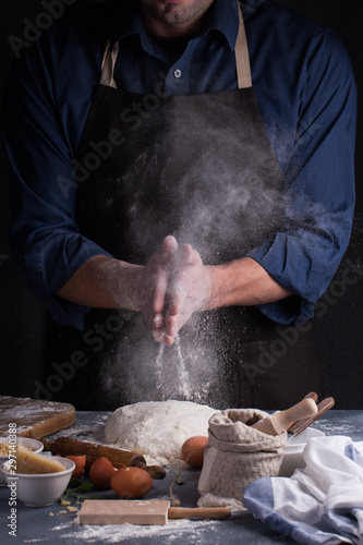 Baker prepares the dough on table. Homemade pastry.