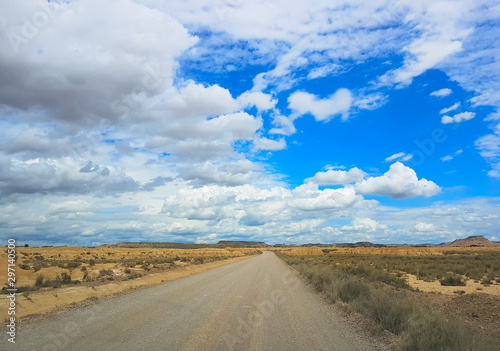 Gravel road across the Spanish desert Bardenas Reales in the southeast of Navarre