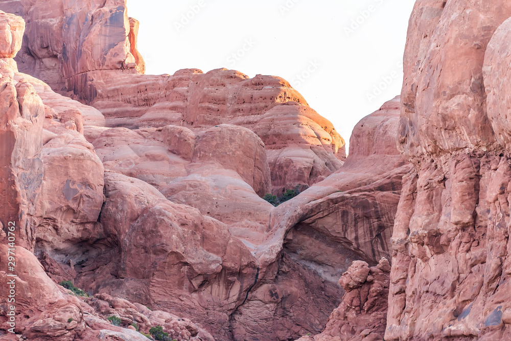 Unique formation near Double arch in Arches National Park in Utah during morning sunrise with red pink rock color