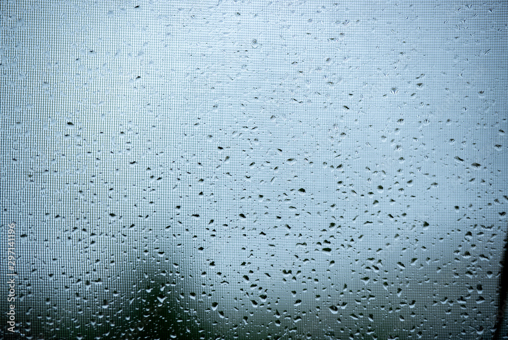 Raindrops on a mosquito net. Mosquito net on a window with a curtain. Horizontal photo, macro. Raindrops on a mosquito net. Mosquito net on a window with a curtain. Horizontal photo, macro.