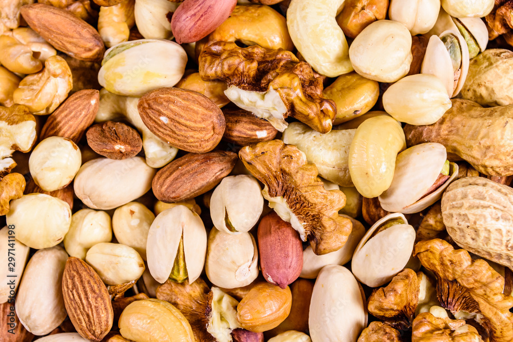 Background of the various nuts (almond, cashew, hazelnut, pistachio, walnut). Vegetarian meal. Healthy eating concept Background of the various nuts (almond, cashew, hazelnut, pistachio, walnut). Vegetarian meal. Healthy eating concept