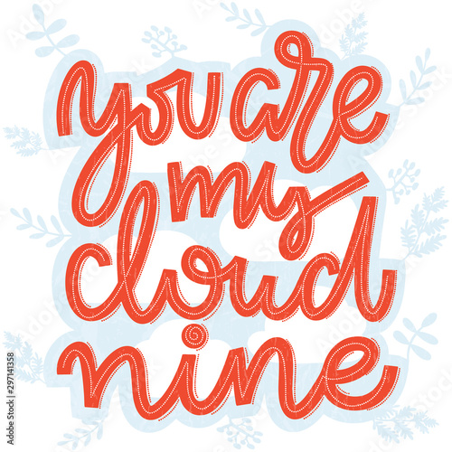 Coral pink lettering saying You are my cloud nine. Handwritten romantic lettering in coral and white on blue and white cloud and twigs and leaves background. Template for greeting and postcards