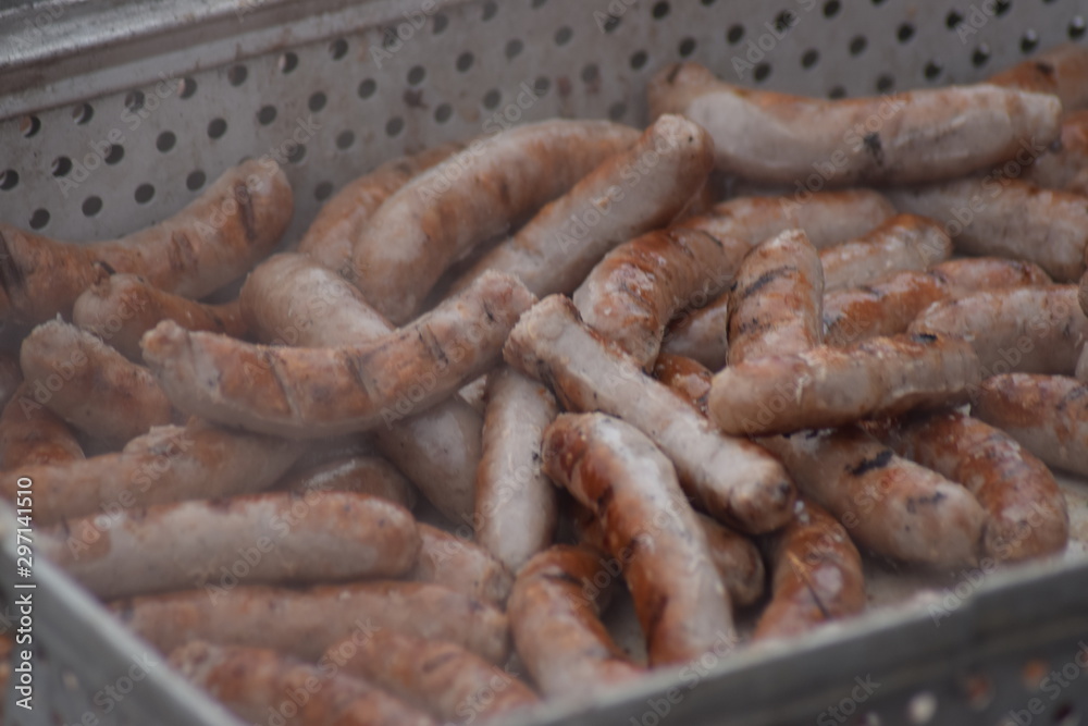 Container full of cooked sausages of a barbecue Container full of cooked sausages of a barbecue