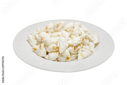 Top view of pile of fresh steamed crab meat without shell and ready to eat on white dish isolated on white background.